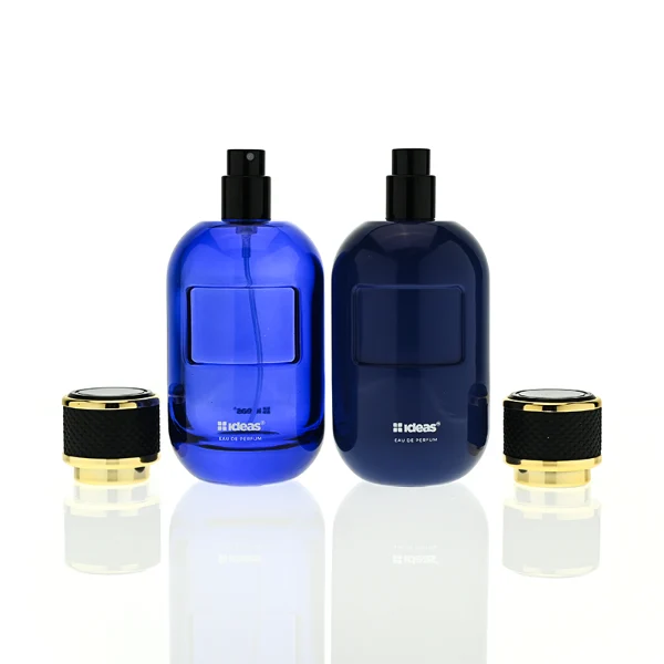 HUA0420 perfume bottle, luxury 100ml rounded oval glass bottle with translucent deep multi-color finish in red, grey, green, or brown, featuring a gold-colored aluminum label and a black textured leather-wrapped plastic cap with gold-colored trim, modern elegant fragrance packaging design
