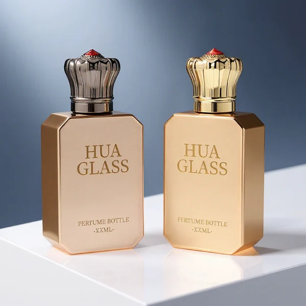 HUA0422 perfume bottle, luxury electroplated beveled corner square glass bottle with mirror gloss finish in gold or rose gold, featuring a unique crown-shaped zamak cap with a red gemstone tip, premium regal fragrance packaging design available in 30ml, 50ml, and 100ml