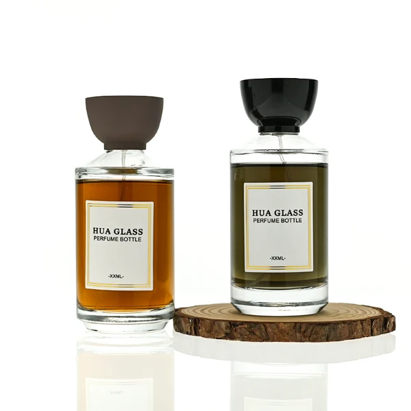 HUA0424 perfume bottle, luxury heavy-base cylindrical glass bottle with translucent deep multi-color finish, featuring a gold-bordered square paper label, a black neck ring, and a unique glossy black tapered cup-shaped plastic cap, modern elegant fragrance packaging design available in 30ml, 50ml, and 100ml