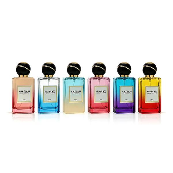 HUA0426 perfume bottle, luxury heavy-base rectangular square glass bottle with high-transparency finish showing colored liquid, featuring a gold-bordered square paper label and a unique round ball plastic cap with a diagonal gold-colored accent stripe, modern elegant fragrance packaging design available in 30ml, 50ml, and 100ml