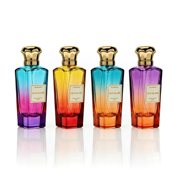 HUA0427 perfume bottle, luxury heavy-base tapered faceted glass bottle with high-transparency finish showing colored liquid, featuring a gold-bordered square paper label and a unique wavy crown-shaped zamak cap with a high-shine gold or silver finish, modern elegant fragrance packaging design available in 50ml and 75ml