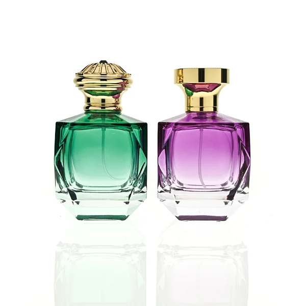 HUA0428 perfume bottle, luxury heavy-base multi-faceted angular square glass bottle with high-transparency finish showing colored liquid, featuring a matching gold-colored neck collar and an ornate crown-style zamak cap with a high-shine gold finish, premium regal fragrance packaging design available in 30ml, 50ml, and 100ml