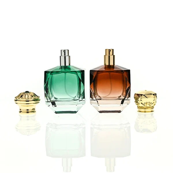 HUA0428 perfume bottle, luxury heavy-base multi-faceted angular square glass bottle with high-transparency finish showing colored liquid, featuring a matching gold-colored neck collar and an ornate crown-style zamak cap with a high-shine gold finish, premium regal fragrance packaging design available in 30ml, 50ml, and 100ml