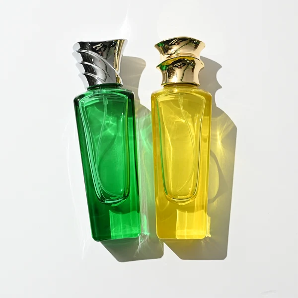HUA0438 perfume bottle, luxury heavy-base elongated rectangular glass bottle with translucent deep multi-color finish, featuring a unique irregular bamboo-joint solid Zamak cap with a mirror-shine glossy metallic finish, modern elegant fragrance packaging design available in 50ml and 75ml