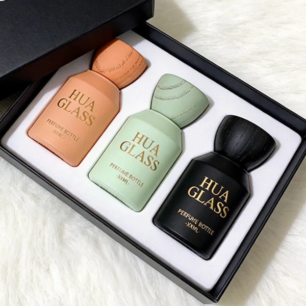 HUA0440 perfume bottle, luxury heavy-base matte finish cylindrical glass bottle with sloped shoulders, featuring a unique egg-shaped natural textured wooden cap showcasing visible organic wood grains in matching colorways, minimalist elegant fragrance packaging design available in 30ml, 50ml, and 100ml