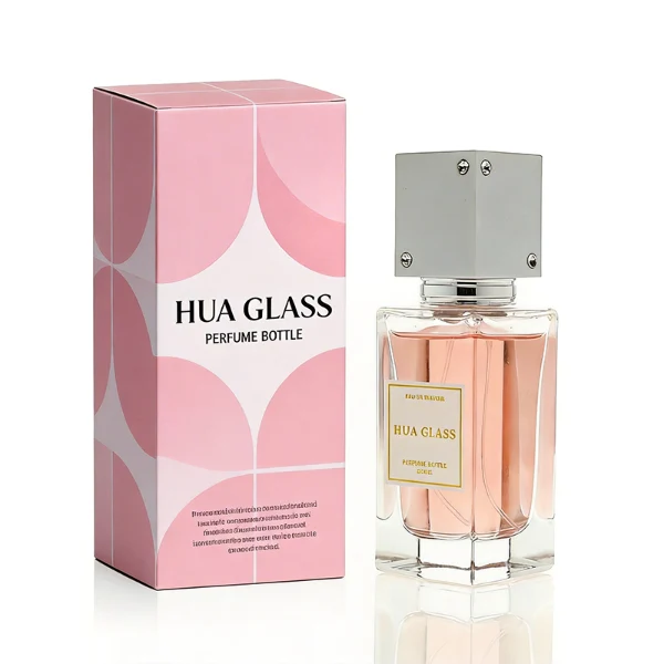 Two tall rectangular clear glass perfume bottles stand side by side, filled with light pink and grey-green liquids. Both feature a white square label and are topped with tall cube caps accented by tiny corner rhinestones—presented in white with a silver collar on the left, and black with a gold collar on the right.