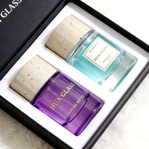 HUA0445 perfume bottle features a thick-bottomed cylindrical glass body paired with a modern textured cylindrical plastic cap. Designed for wholesalers, it offers 30ml, 50ml, and 100ml capacity options, combining an elegant round design with practical durability for diverse fragrance lines.