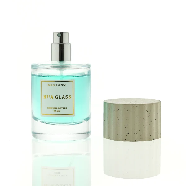 HUA0445 perfume bottle features a thick-bottomed cylindrical glass body paired with a modern textured cylindrical plastic cap. Designed for wholesalers, it offers 30ml, 50ml, and 100ml capacity options, combining an elegant round design with practical durability for diverse fragrance lines.