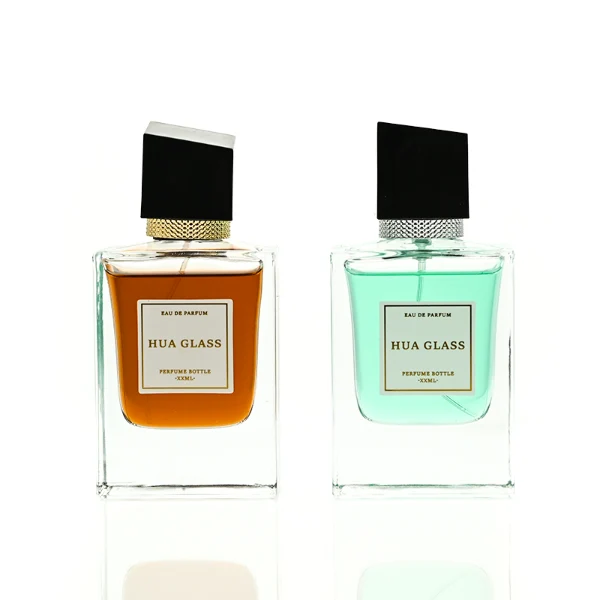 HUA0447 perfume bottle features a clear, thick-bottomed rectangular glass body with a modern cube-shaped plastic cap. Designed for wholesalers, it offers a 50ml capacity option, combining a sleek angular design with durable functionality for premium fragrance lines.