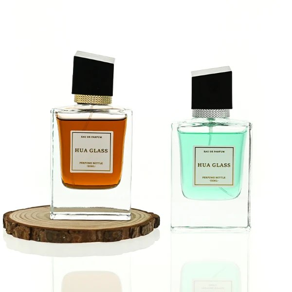 HUA0447 perfume bottle features a clear, thick-bottomed rectangular glass body with a modern cube-shaped plastic cap. Designed for wholesalers, it offers a 50ml capacity option, combining a sleek angular design with durable functionality for premium fragrance lines.
