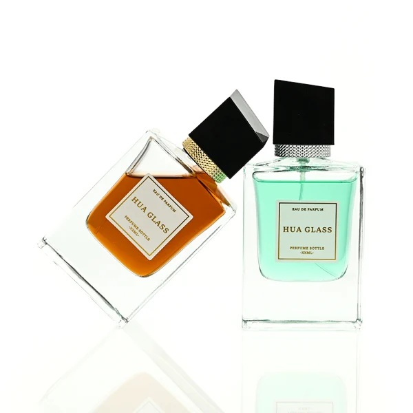 HUA0447 perfume bottle features a clear, thick-bottomed rectangular glass body with a modern cube-shaped plastic cap. Designed for wholesalers, it offers a 50ml capacity option, combining a sleek angular design with durable functionality for premium fragrance lines.