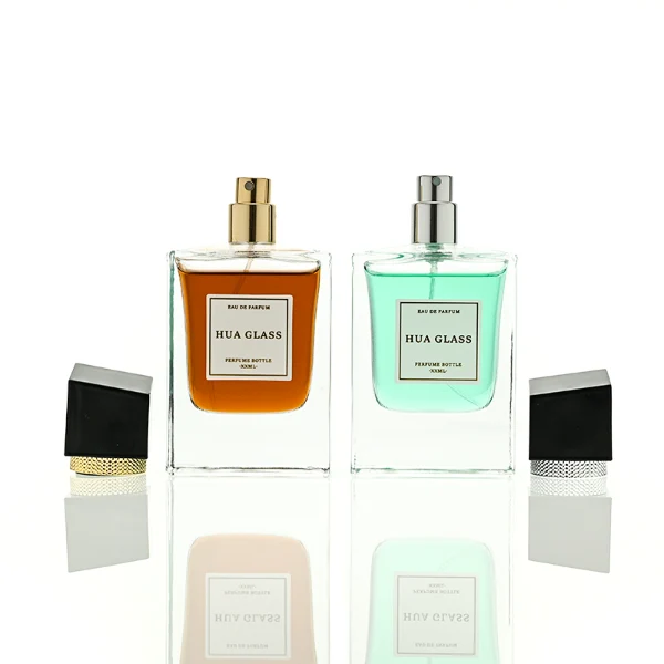 HUA0447 perfume bottle features a clear, thick-bottomed rectangular glass body with a modern cube-shaped plastic cap. Designed for wholesalers, it offers a 50ml capacity option, combining a sleek angular design with durable functionality for premium fragrance lines.