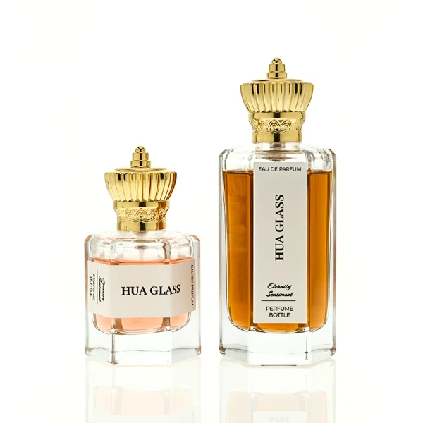 HUA0451 perfume bottle features a clear hexagonal glass body paired with an ornate crown-shaped plastic cap in gold or silver. Designed for wholesalers, it offers 50ml and 100ml choices, combining a regal aesthetic with structural durability for diverse fragrance lines.