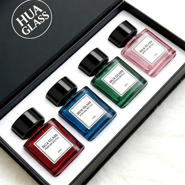 HUA0452 perfume bottle features a clear rounded square glass body paired with a smooth, thick cylindrical plastic cap. Designed for wholesalers, it offers 30ml, 50ml, and 100ml capacity options, combining an elegant minimalist design with functional durability.