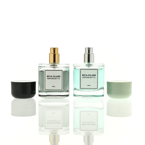 HUA0452 perfume bottle features a clear rounded square glass body paired with a smooth, thick cylindrical plastic cap. Designed for wholesalers, it offers 30ml, 50ml, and 100ml capacity options, combining an elegant minimalist design with functional durability.