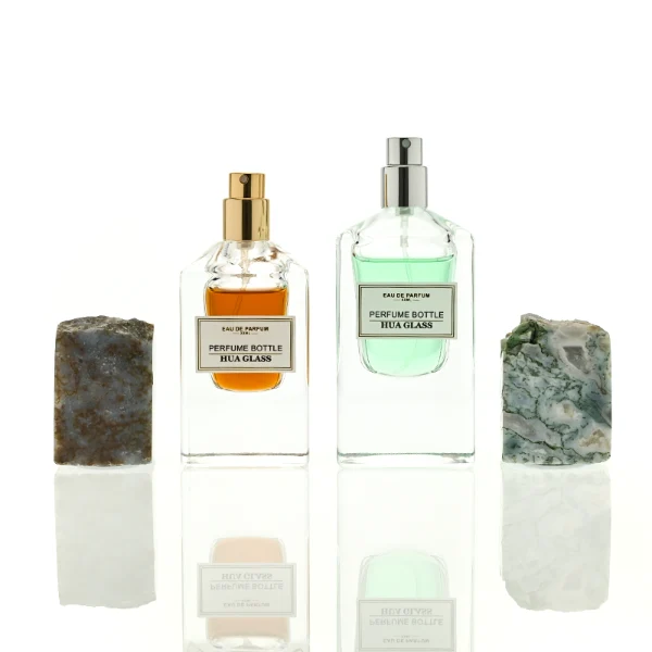 HUA0457 perfume bottle showcases a clear, thick-bottomed rectangular glass frame paired with a striking, unique block cap made of raw natural stone. Designed for premium wholesale markets, it offers 30ml and 50ml options, combining an organic elemental style with architectural structural durability.