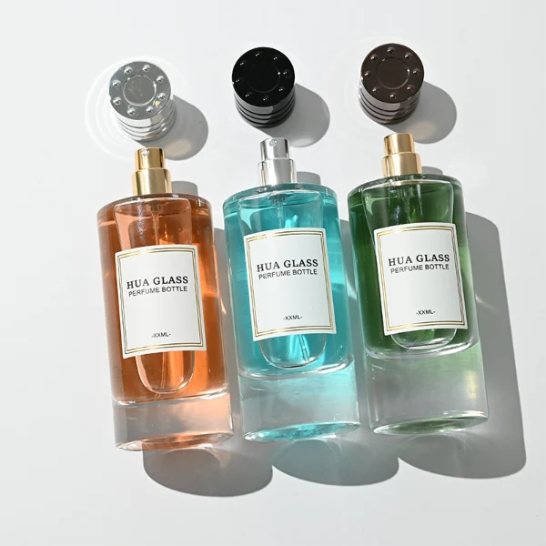 HUA0458 perfume bottle features a clear, thick-bottomed cylindrical glass body paired with a ribbed cylindrical plastic cap in black, brown, or silver. it offers 80ml and 85ml capacity choices, combining a classic round profile with reliable durability for wholesale fragrance markets.