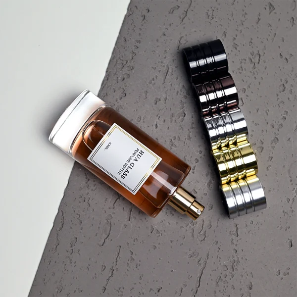 HUA0458 perfume bottle features a clear, thick-bottomed cylindrical glass body paired with a ribbed cylindrical plastic cap in black, brown, or silver. it offers 80ml and 85ml capacity choices, combining a classic round profile with reliable durability for wholesale fragrance markets.