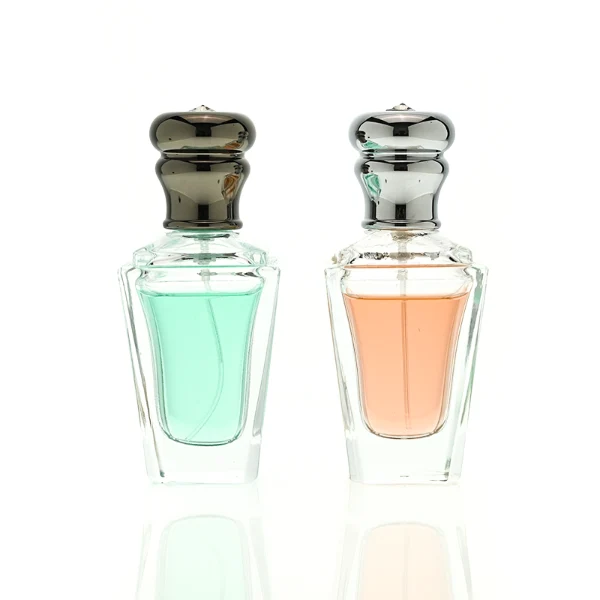 HUA0459 perfume bottle, features an architectural, angular clear glass body with a tapered silhouette, paired with a heavy metallic crown-shaped Zamac cap. Designed for luxury wholesalers, it offers a 50ml capacity option blending upscale geometric lines with premium durability.