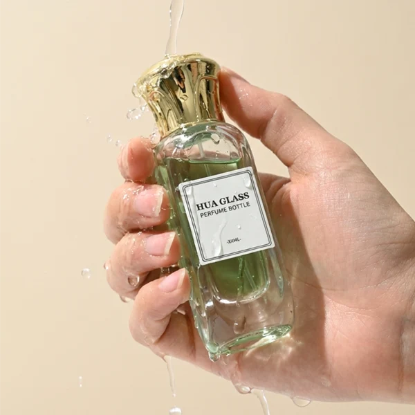 A luxury rectangular perfume bottle featuring a thick, rounded clear glass base and a heavy metallic crown-shaped Zamac cap in gold, silver, or black.