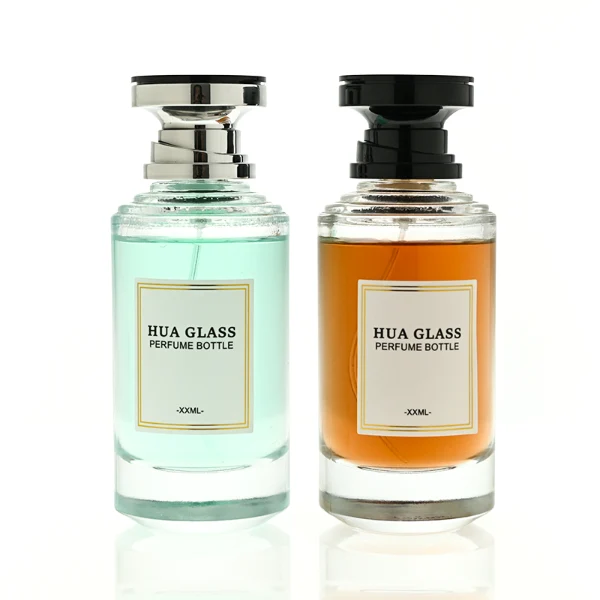 A thick-bottomed cylindrical glass perfume bottle featuring a round, curved profile with gradient color finish choices like black, blue, pink, or brown, topped with a uniquely styled injection-molded plastic cap in black or white.