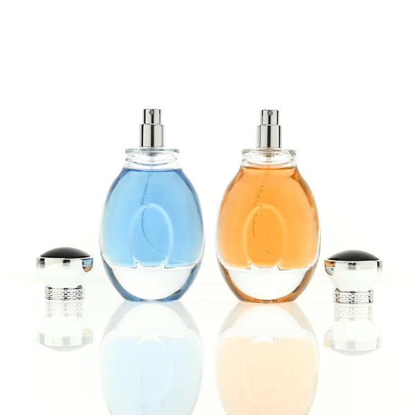 A 100ml clear glass perfume bottle with a smooth, globular curved profile and a thick base. The neck features a detailed metallic collar paired with a silver crown-motif cap topped with a dark glossy insert.