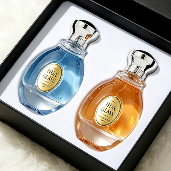 A 100ml clear glass perfume bottle with a smooth, globular curved profile and a thick base. The neck features a detailed metallic collar paired with a silver crown-motif cap topped with a dark glossy insert.