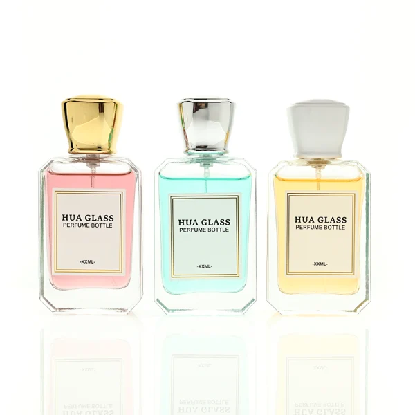 A diamond-cut rectangular glass perfume bottle with a clear, angular profile and an elegant faceted border, paired with a smooth, trapezoidal square plastic cap available in gold, silver, or matte white.