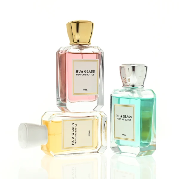 A diamond-cut rectangular glass perfume bottle with a clear, angular profile and an elegant faceted border, paired with a smooth, trapezoidal square plastic cap available in gold, silver, or matte white.