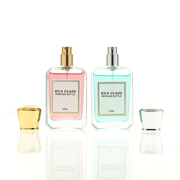 A diamond-cut rectangular glass perfume bottle with a clear, angular profile and an elegant faceted border, paired with a smooth, trapezoidal square plastic cap available in gold, silver, or matte white.