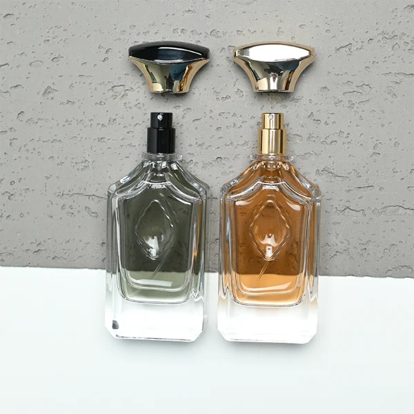 A diamond-cut rectangular clear glass perfume bottle with faceted corners and textured vertical ridges along the upper shoulders, paired with a unique flared, curved plastic cap available in solid gold or black-and-gold finish.