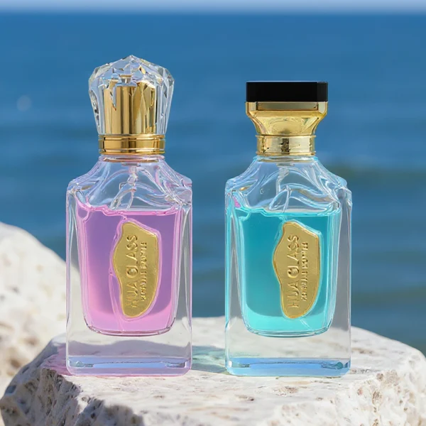A thick-bottomed rectangular clear glass perfume bottle with faceted upper corners, shown with two cap variations: a crystal-clear faceted crown-shaped cap with a gold core, and a flared gold cap topped with a flat black cube block.
