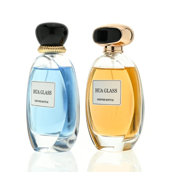 a globular curved clear glass perfume bottle features an oval silhouette with a heavy base, paired with a smooth, pebble-shaped plastic cap available in glossy solid black with a ribbed gold collar, or a flat-oval black design encased in a gold border.