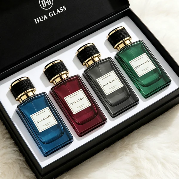 a clear rectangular glass perfume bottle features rounded shoulders and a thick square base, paired with a textured cylindrical plastic cap detailed with a micro-diamond knurled pattern and bordered by shiny gold metallic trim, available in black-and-gold or brown-and-gold finishes.