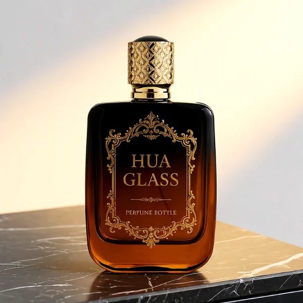 Three flat rectangular perfume bottles with rounded corners are shown in a row. The bottles feature semi-translucent glass bodies in soft grey-blue, delicate pink, and a dark amber-to-black gradient. Each is paired with a cylindrical rose-gold cap detailed with an intricate engraved geometric pattern and capped with a smooth, domed insert on top.