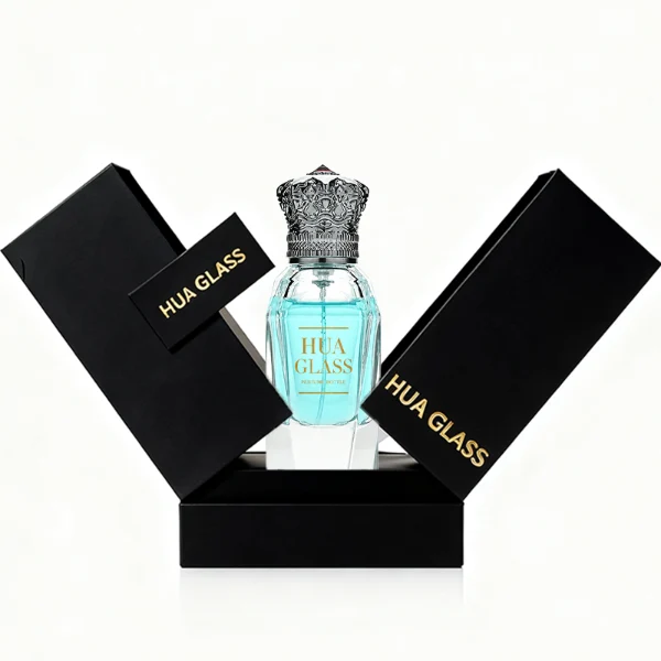 Three clear glass perfume bottles with faceted, angular bodies and heavy, thick bases are shown containing amber, light blue, and olive green liquids. Each bottle is topped with an ornate, highly detailed Zamac crown-motif cap featuring intricate filigree metalwork and a small red pointed gem accent at the peak, presented in polished gold, bright silver, and dark gunmetal finishes.