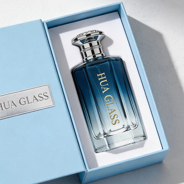 HUA0439 perfume bottle, luxury heavy-base polyhedral angular glass bottle with translucent deep multi-color gradient finish, featuring a crown-shaped flared hourglass solid Zamak cap with an intricately sculpted silver-colored glossy metallic finish, modern elegant fragrance packaging design available in 50ml and 100ml