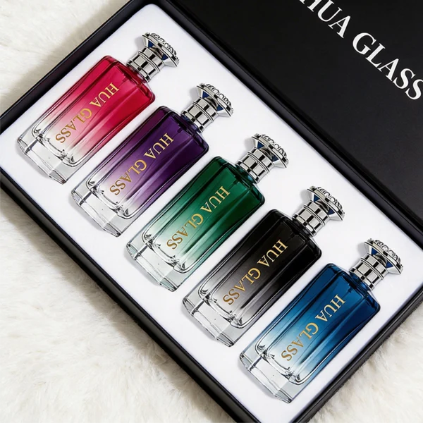 HUA0439 perfume bottle, luxury heavy-base polyhedral angular glass bottle with translucent deep multi-color gradient finish, featuring a crown-shaped flared hourglass solid Zamak cap with an intricately sculpted silver-colored glossy metallic finish, modern elegant fragrance packaging design available in 50ml and 100ml