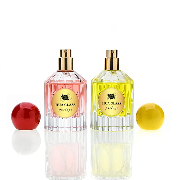 HUA0261 perfume bottle, transparent glass body with radiating cut facets on the upper section and multifaceted cut pattern on the lower section, 50 ml liquid, oversized spherical plastic cap with glossy finish in red or yellow color, gold-tone printed logo label, retro luxury design, ideal for gifting and daily use.