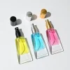 HUA0297 perfume bottle, transparent colorless cosmetic tube-inspired glass body with asymmetrical sculptural silhouette and bamboo base, 10 ml liquid, integrated natural bamboo cap, clean glass surface without logo printing, artistic modern minimalist design, ideal for travel and gifting.